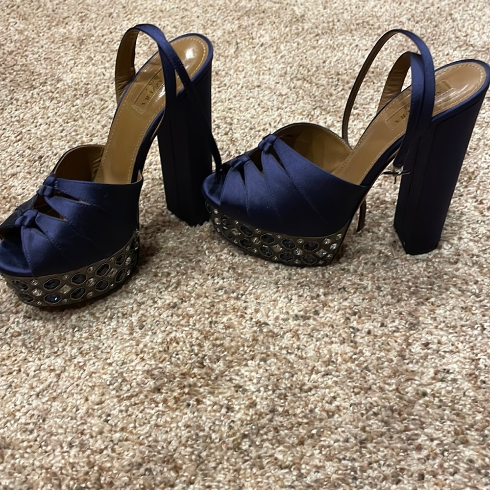 Aquazzura platform sandals in navy with gem studded medal platform wrap.